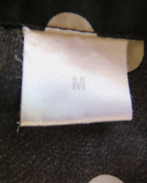 Sheer black and white polkadot button down top with tiny cut on sleeves. Size 34/10.As new cond.