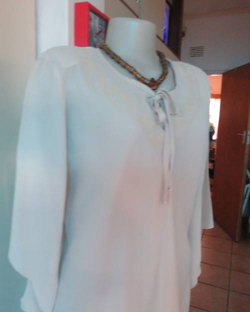 Beautiful wheat polyester slip over top Long angel sleeves.Scooped neckline with tiestring.Size 44