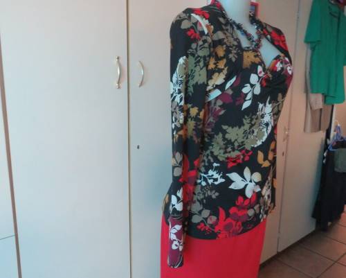 Black stretch polyester background with red,purple and gold floral pattern top.Tiny bolero.Size 38