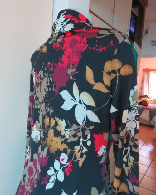 Black stretch polyester background with red,purple and gold floral pattern top.Tiny bolero.Size 38