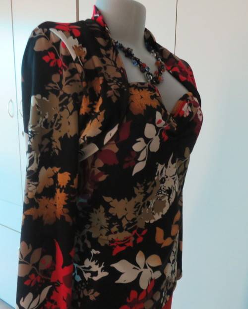 Black stretch polyester background with red,purple and gold floral pattern top.Tiny bolero.Size 38
