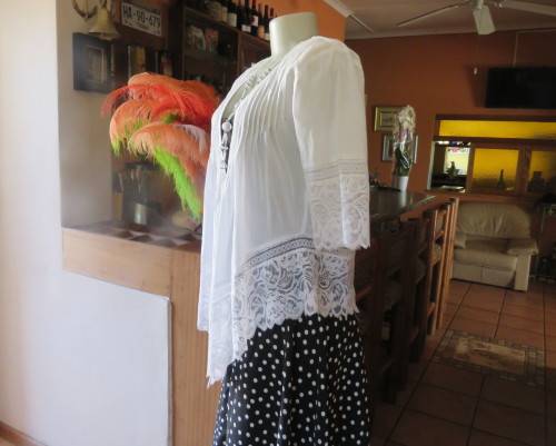 Dainty fine cotton waterfall style white top.Tuckking and lace decoration.One button closure.Size 36