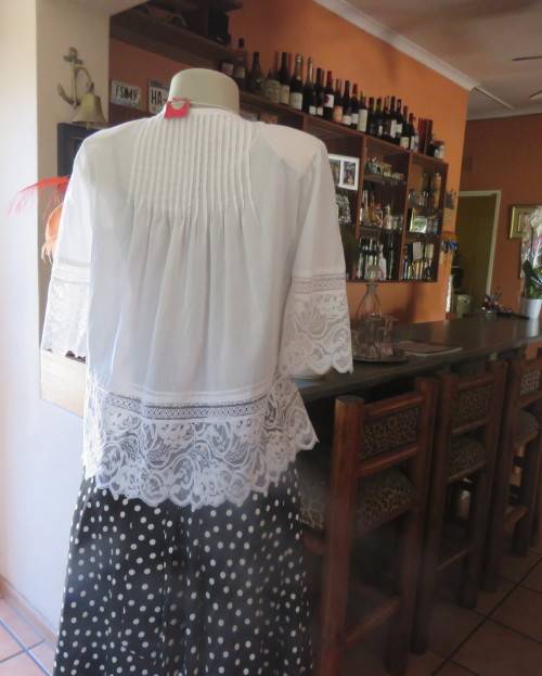 Dainty fine cotton waterfall style white top.Tuckking and lace decoration.One button closure.Size 36