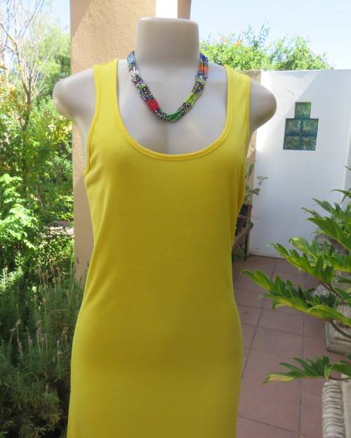 As new buttercup yellow maxi sleeveless dress. Scooped neckline.Size 36/12.Polyester/viscose.