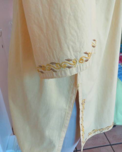 As new buttercup yellow richly embroidered top.Bracelet length sleeves.By BABA forn Kashmi.Size 40