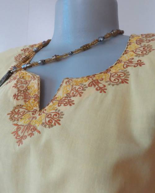 As new buttercup yellow richly embroidered top.Bracelet length sleeves.By BABA forn Kashmi.Size 40