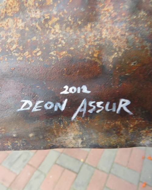Interesting junk art by DEON ASSUR 2012. Painting of 3 enamel mugs on rusted plate.Size 58 x 25cm.