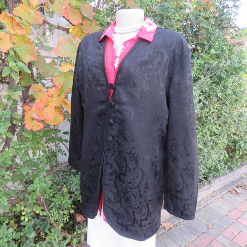 Stunning black boutique made brocade fully lined long sleeve collar less jacket. Size 42/18.New cond