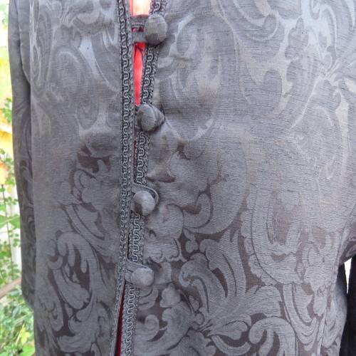 Stunning black boutique made brocade fully lined long sleeve collar less jacket. Size 42/18.New cond