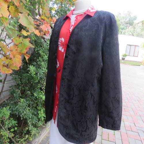 Stunning black boutique made brocade fully lined long sleeve collar less jacket. Size 42/18.New cond
