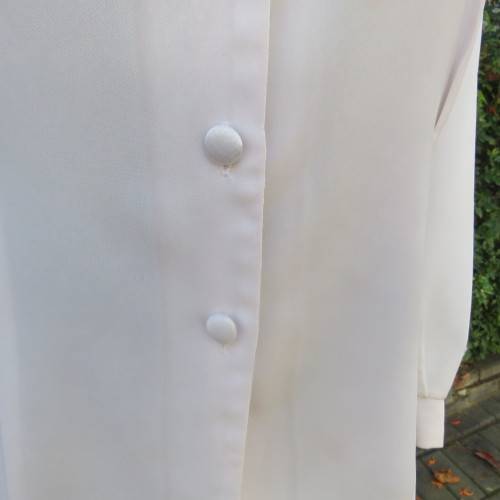 Smart long sleeve off-white top. Button down with satin covered buttons/shirt collar.Size 40. M.H.