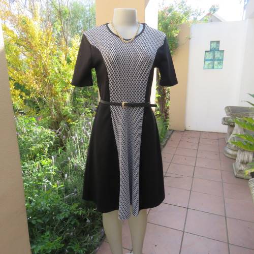 Lovely slip over black stretch polyester short sleeve dress with monochrome front inlay. Size 34/10.
