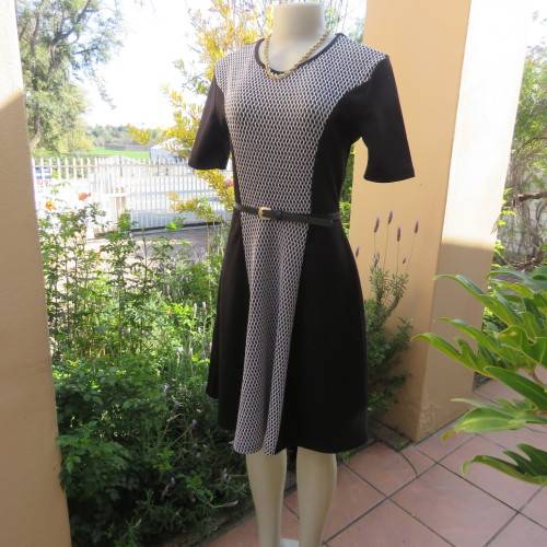 Lovely slip over black stretch polyester short sleeve dress with monochrome front inlay. Size 34/10.