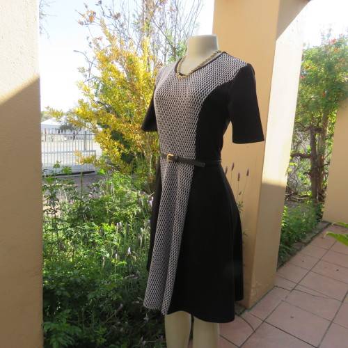 Lovely slip over black stretch polyester short sleeve dress with monochrome front inlay. Size 34/10.