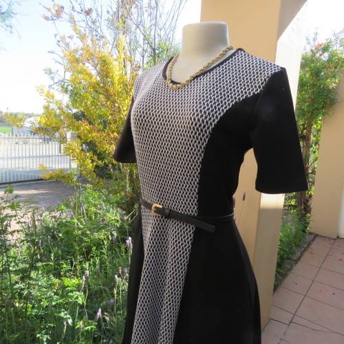 Lovely slip over black stretch polyester short sleeve dress with monochrome front inlay. Size 34/10.