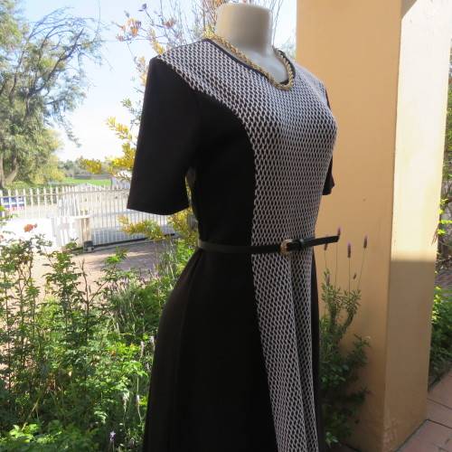 Lovely slip over black stretch polyester short sleeve dress with monochrome front inlay. Size 34/10.