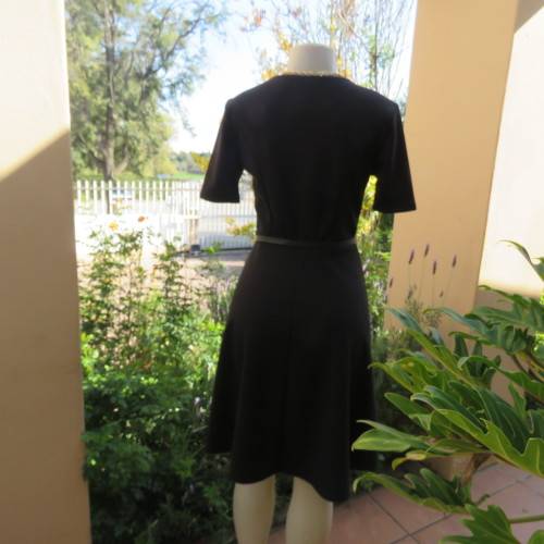 Lovely slip over black stretch polyester short sleeve dress with monochrome front inlay. Size 34/10.