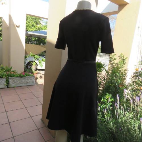 Lovely slip over black stretch polyester short sleeve dress with monochrome front inlay. Size 34/10.