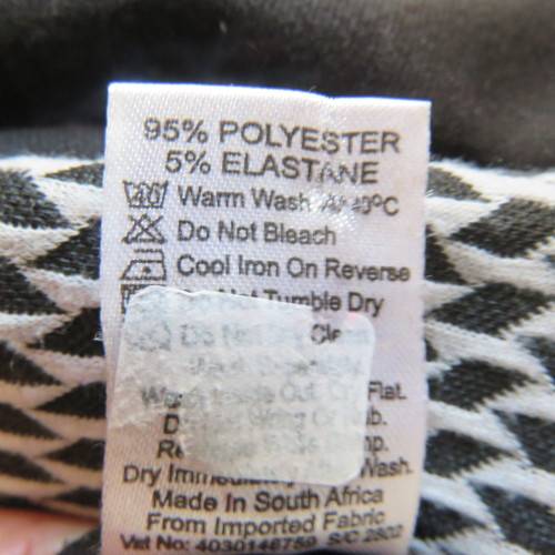 Lovely slip over black stretch polyester short sleeve dress with monochrome front inlay. Size 34/10.