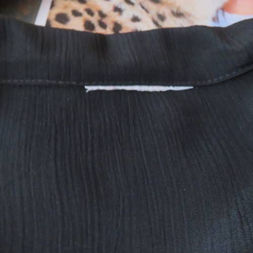 Lovely black silky polyester button down top. Tiny cut-on sleeves. Wide pointed collar. Size 40/16.