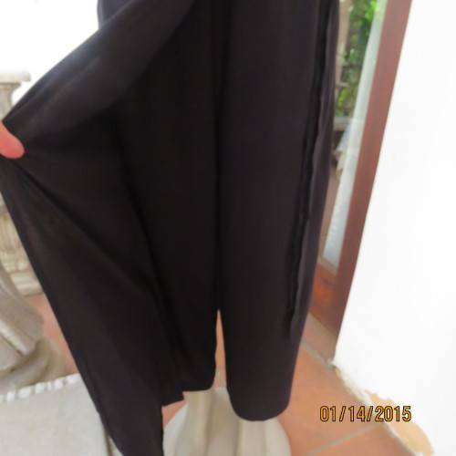 Elegant modern black jumpsuit with foldover skirt front. In 100% rayon.High collar.Size 38/14.As new