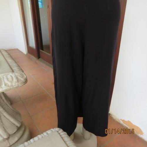 Elegant modern black jumpsuit with foldover skirt front. In 100% rayon.High collar.Size 38/14.As new