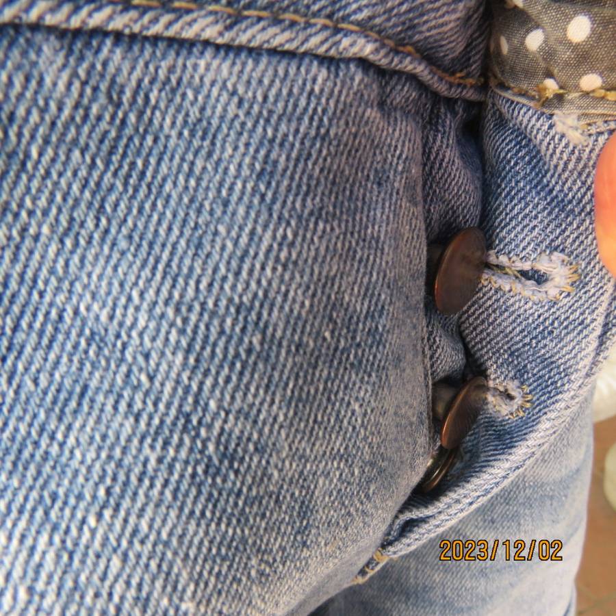 Distressed look denim shorts size 38/14 with turnover legs. Buttoned fly. Pockets back/front.