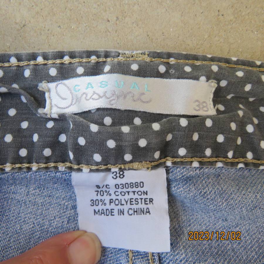 Distressed look denim shorts size 38/14 with turnover legs. Buttoned fly. Pockets back/front.