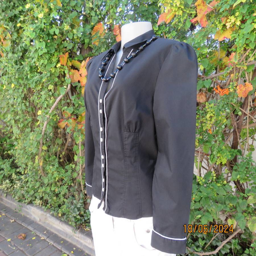Charming long sleeves black tailored top. V button down front/collar. White edging/buttons.Size 36.