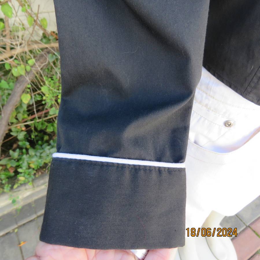 Charming long sleeves black tailored top. V button down front/collar. White edging/buttons.Size 36.