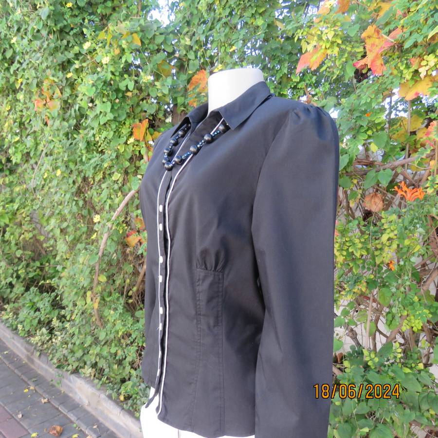 Charming long sleeves black tailored top. V button down front/collar. White edging/buttons.Size 36.