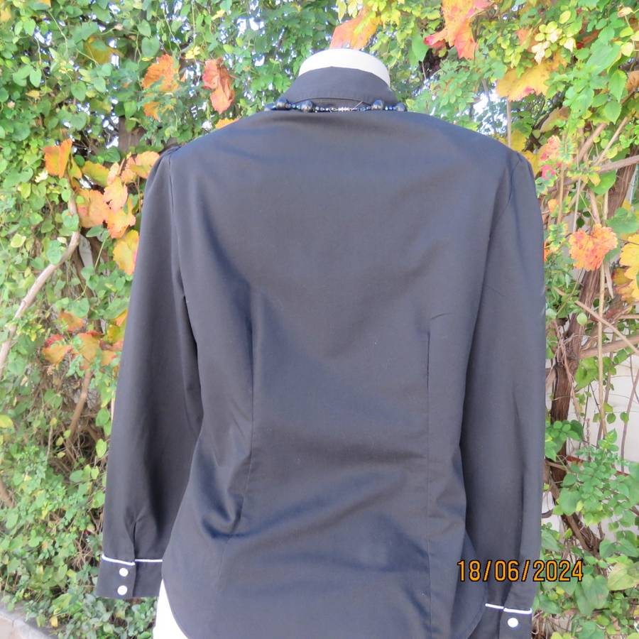 Charming long sleeves black tailored top. V button down front/collar. White edging/buttons.Size 36.