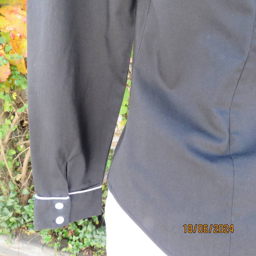 Charming long sleeves black tailored top. V button down front/collar. White edging/buttons.Size 36.