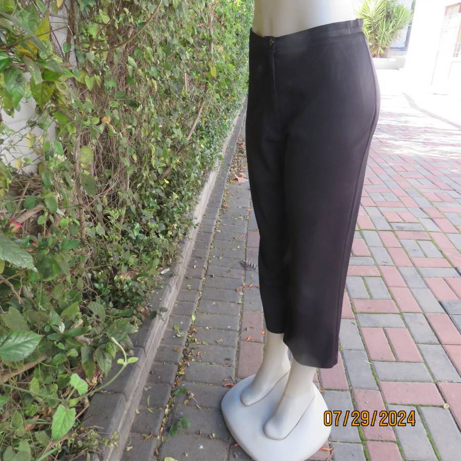 Black silky,shiny stretch polyester ankle length pants by MERIEN HALL size 35. Very good condition