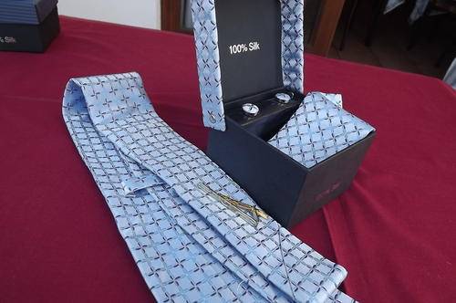 Boxed 100% silk 4 piece tie set.Beautifully patterned with crosses on light blue background.Width 10