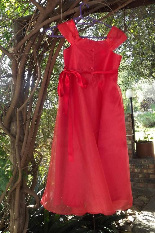 Bright red sheer polyester special occasions dress for 8-9 year old girl.Button down at back.Fully l