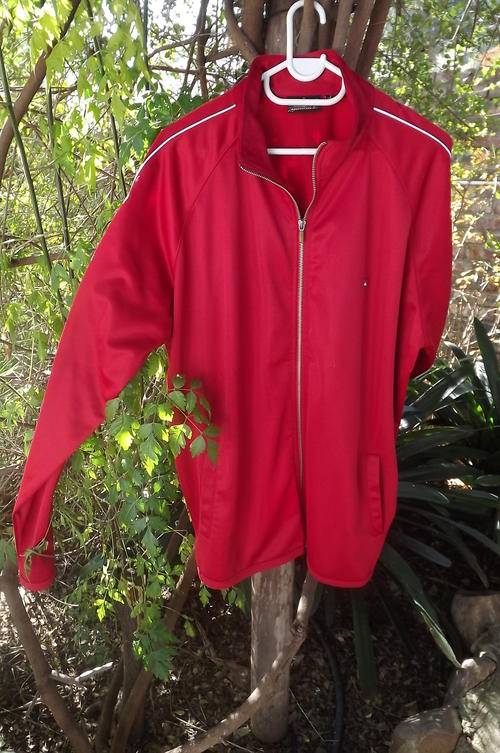 Red Quicksilver zipped up jacket.100% Polyester.Fleezy inside.Size XL.High neckline.Good used condit
