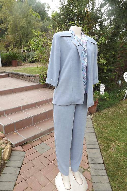 Beautiful Light Blue Caviar Pant Suit. Jacket size 34/ Pants 36 for comfortable fit.New condition.