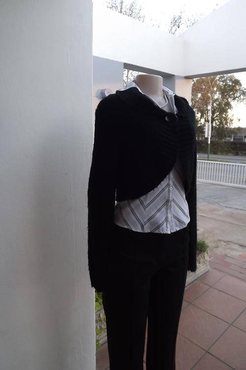 Black soft knitted bolero top closing with 1 large button on front.Size 36/12.Wide fold over collar.