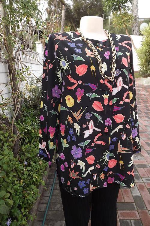 Fabulous black polyester collarless long top with striking print.Size 40/16.Hidden buttons on front.