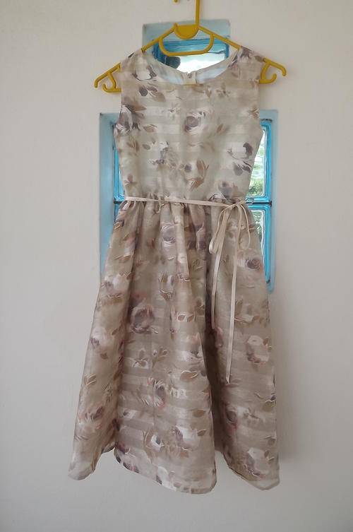 Pretty special occasion dress in  sheer cream polyester with suble purple/brown roses.  8 to 9 years