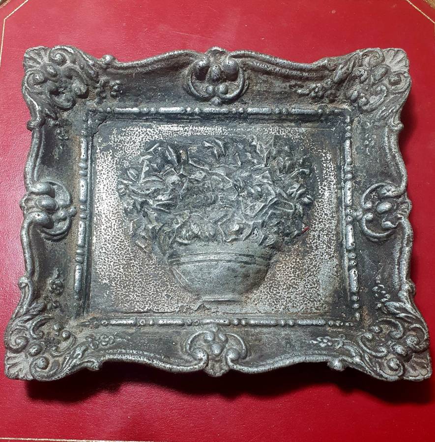 Antique cast iron framed flowers wall plate.