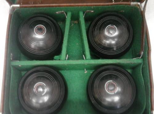 SET OF FOUR BOWLING BALLS IN CASE SIZE OF BALLS ARE  4 7/8