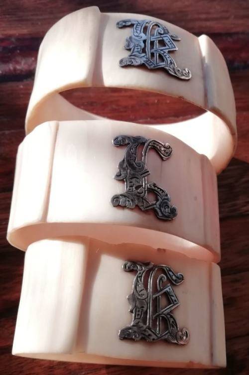 FROM THE VICTORIAN ERA | COLLECTIBLE SET OF 3 IVORY SERVIETTE RINGS EMBELLISHED WITH SILVER LETTERS