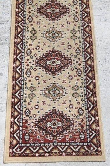 A FABULOUS 2.6m LONG "KHALAF ORIENT" RUNNER CARPET IN DARK BROWN AND TAN COLOURS