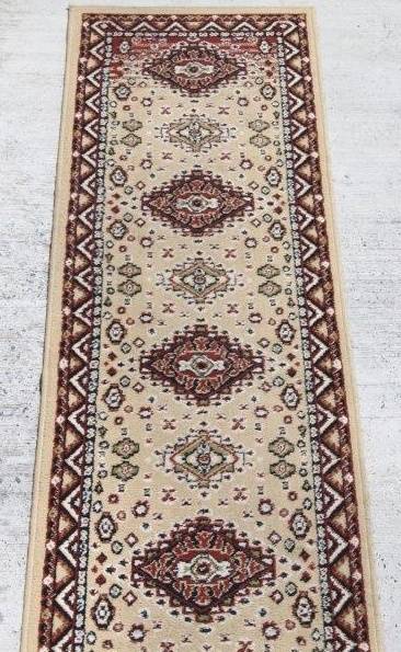A FABULOUS 2.6m LONG "KHALAF ORIENT" RUNNER CARPET IN DARK BROWN AND TAN COLOURS