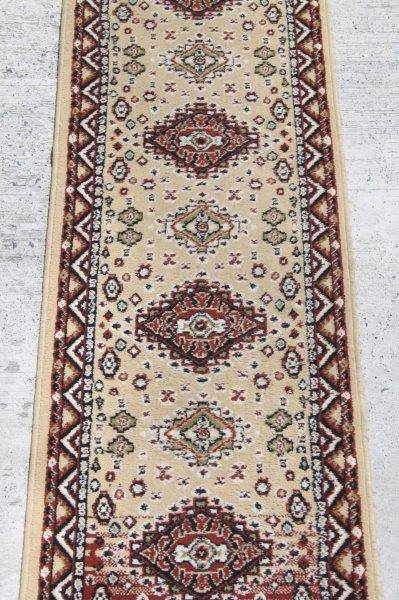 A FABULOUS 2.6m LONG "KHALAF ORIENT" RUNNER CARPET IN DARK BROWN AND TAN COLOURS