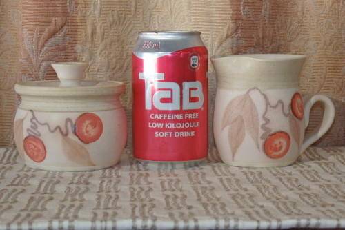 **RS17** A stoneware milk jug and lidded sugar bowl set with gorgeous hand painted detailing