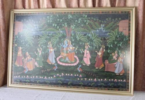 A STUNNING LARGE (1.5m x 1m) PAINTING OF THE HINDU GOD KRISHNA PLAYING THE FLUTE IN A GARDEN