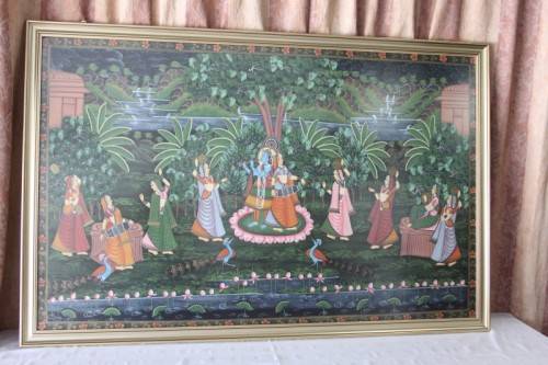 A STUNNING LARGE (1.5m x 1m) PAINTING OF THE HINDU GOD KRISHNA PLAYING THE FLUTE IN A GARDEN